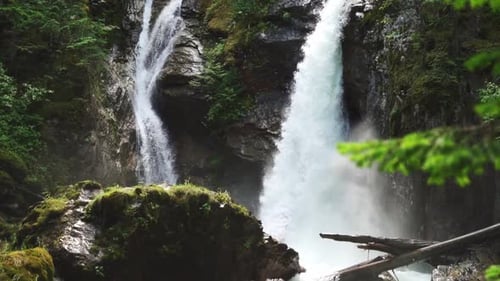 Slow motion pan down a waterfall hitting rocks on the way down
