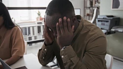 Male Employee Having Migraine from Overwork in Office