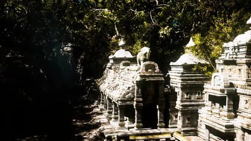 Ancient Temple Complex in Cambodia Surrounded By Lush Greenery and Sunlight