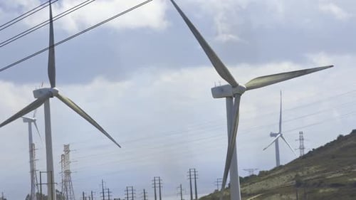 Several Wind Turbines Near Power Lines