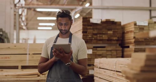 4k video footage of a young man using a digital tablet while working in a workshop