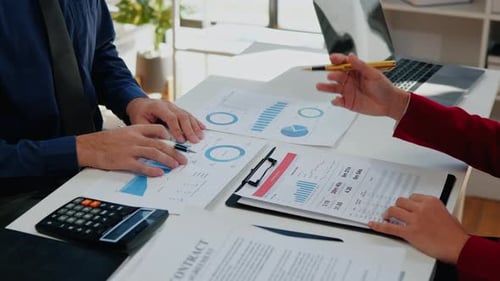 Business People Analyzing Data at White Desk