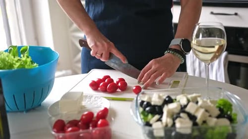 Adult Preparing Salad in Kitchen
