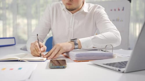 Businessman working stressed and busy at his desk.
