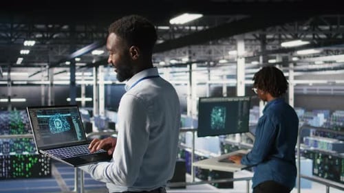 Programmer and Colleague in Data Center Reviewing AI LLM Visualizations