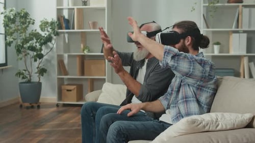 Senior and Young Adult Explore VR Together at Home