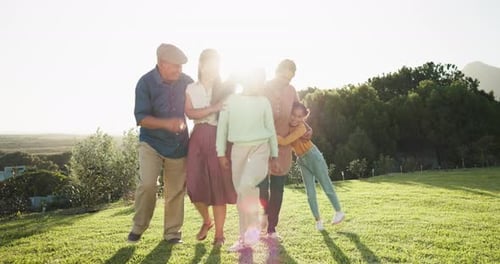 Big family, in garden walking together and excited children bonding with senior people in garden