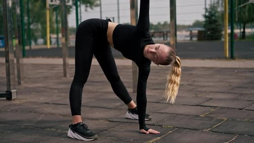 Woman Stretching in Urban Outdoor Setting