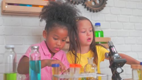 Two Young Girls Conduct a Science Experiment