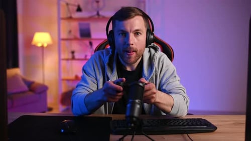 Focused Gamer Plays Video Games at Home