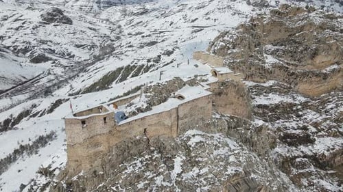Snow Covered Fortress on Mountain Top Aerial View