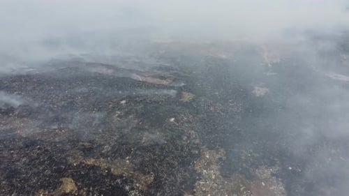 Aerial fly over burning and the land of garbage dump