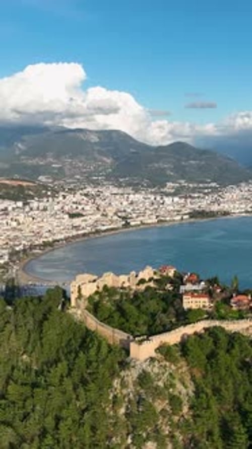 Vertical Video Majestic Coastal Heritage AweInspiring Aerial View of the Ancient Fortress in Alanya