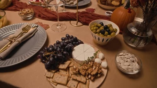 Holiday Dinner Table with Food, Plates and Decorations