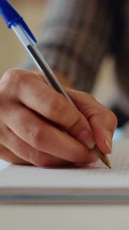 Vertical Video Remote Worker Writing Info on Paper Using Pen Close Up Shot