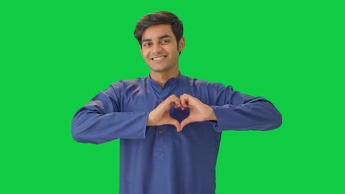 Cute Indian boy showing heart sign Green screen