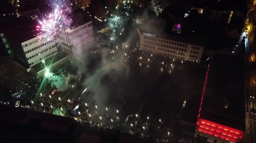 Crowd on Town Square Celebrating New Year With Fireworks, Drone View