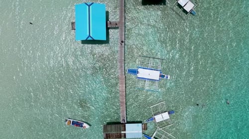Top down view of banca double outrigger boats anchored at pier in balabac islands