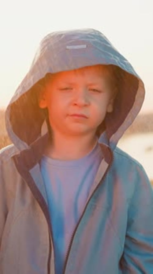 Blond Haired Child in Hooded Coat Looking Forward