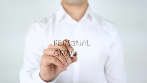 Man Writes Personal Growth on Glass Surface