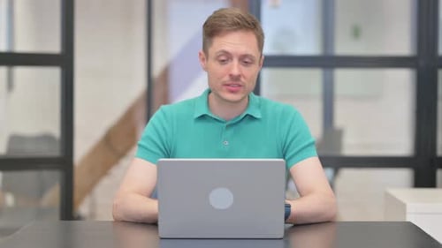 Man Using Laptop in Modern Office