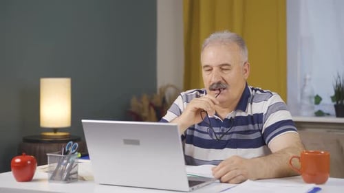 Home office worker old man thoughtful.