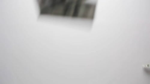 Money Falling in Slow Motion on White Background