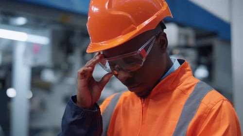 African American Specialist Analyzing Results at Industrial Factory Portrait. Uniformed Supervisor W