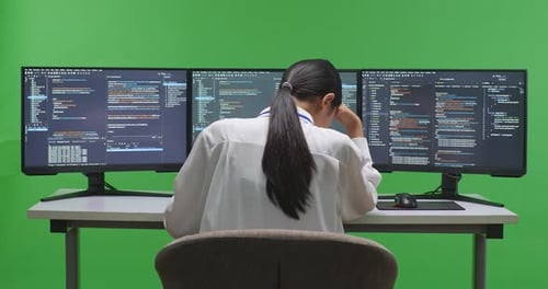Asian Woman Developer Having Headache While Write Code With Multiple Screens In Green Screen Studio