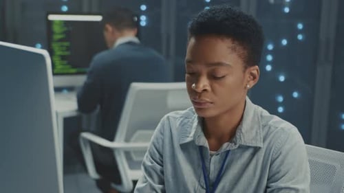 Woman Working at Computer in Data Center