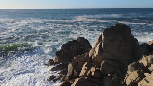 Rocky Cliff By the Ocean with Crashing Waves Sky and Horizon