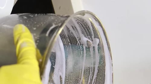 Close Up of Hands Cleaning Metal Object