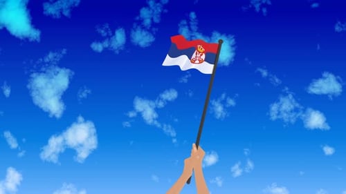 Waving Serbia Flag Held by Hands Against Blue Sky