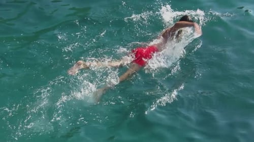 Swimming Body of Attractive Man in Sea Water