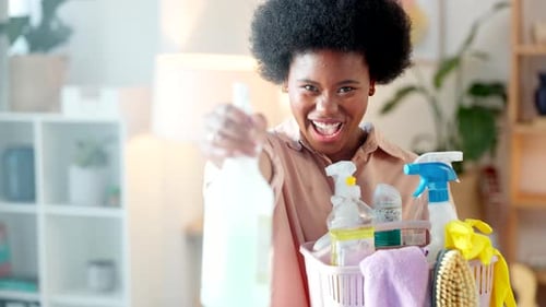 Woman laughing, having fun and spring cleaning at home