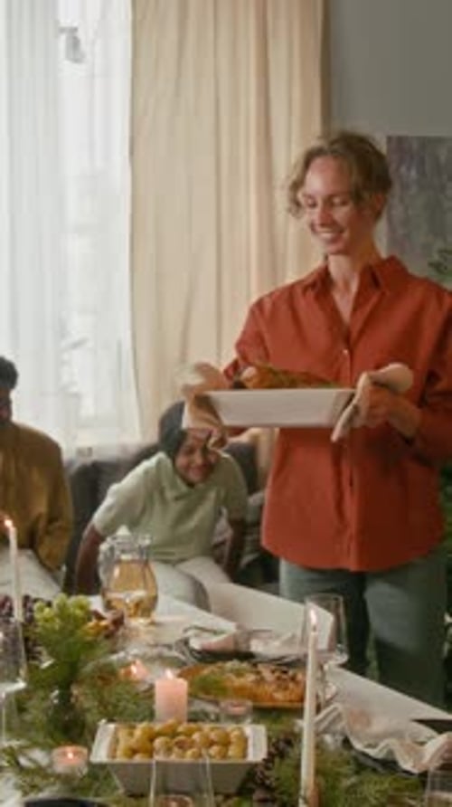 Family Gathers Around Table for Christmas Holiday Meal