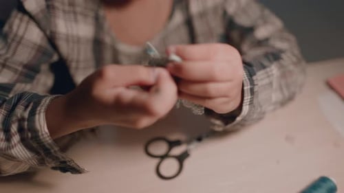 A Schoolage Girl Makes a Craft with Her Own Hands in Her Room at Home
