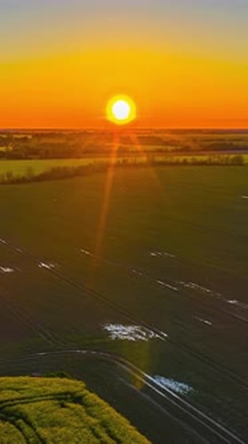 Golden Sunset over Fields: Aerial Rural Beauty