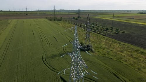 Powerlines Through Green Fields Aerial View