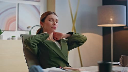 Woman Stretching at Desk During Daytime