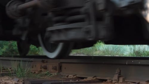 Train Car Moving on Tracks in Countryside