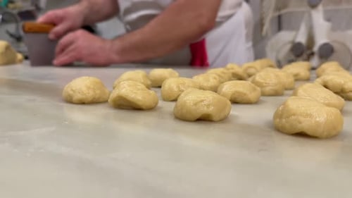 Hands of a white pastry chef preparing handmade pastry dough in a traditional workshop