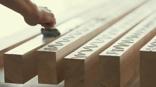 Carpenter Applying and Spreading Wood Glue