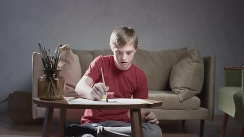 Child Painting With Brush on Paper Indoors
