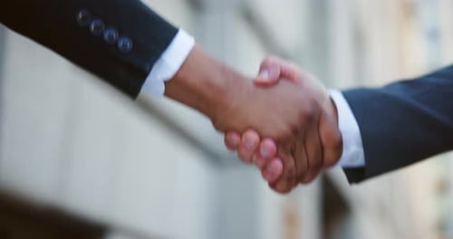 Handshake, deal and business men in city for investment agreement, partnership or meeting
