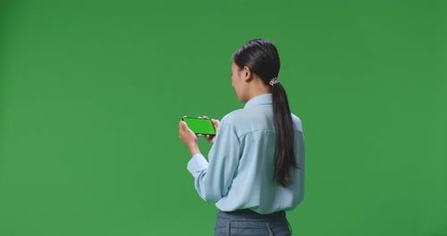 Back View Of Business Woman Using Mobile Phone With Mock Up Green Screen On Green Screen Background