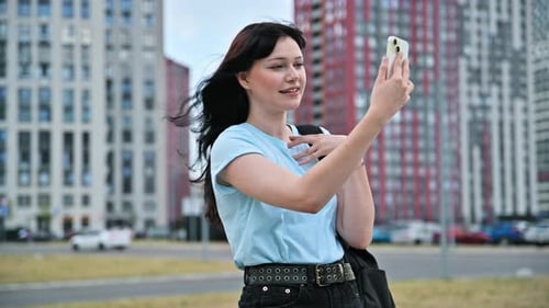 Young Beautiful Woman Having Video Call Chat on Smartphone Outdoor City Background