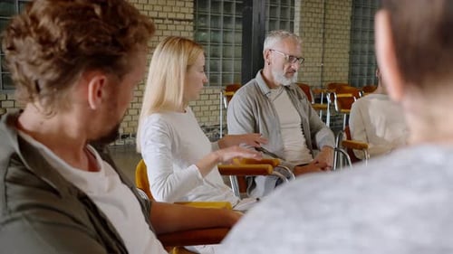 Psychotherapist Talking to Variety of Adults in Circle