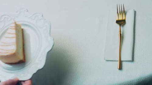 Cheesecake Slice on Plate With Golden Fork