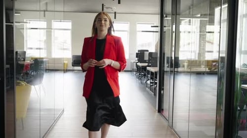Stylish Woman Walking Confidently in Modern Office